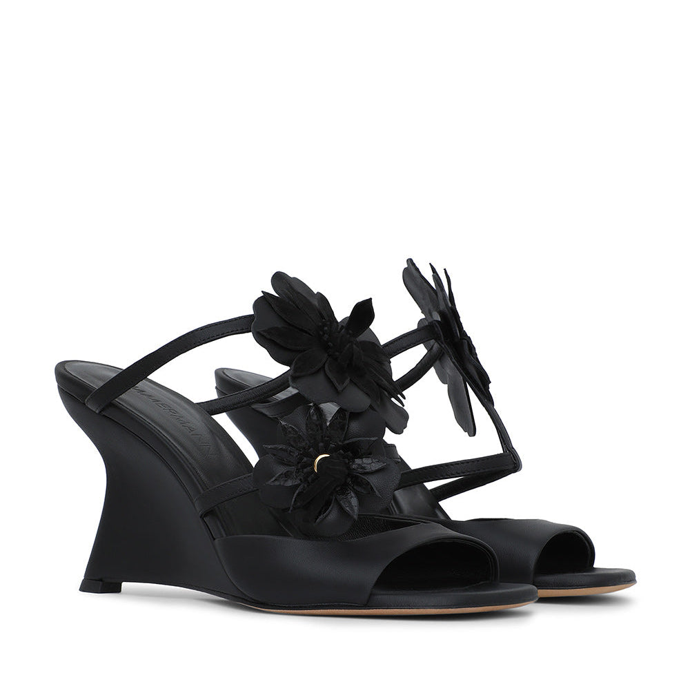 Black Zimmermann Belara Wedge sandals featuring a T-strap design and large floral appliqués.