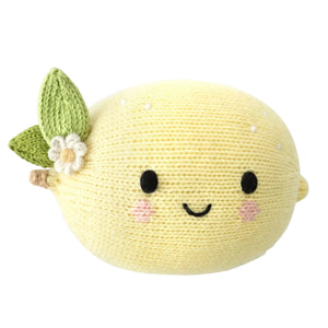 The Cuddle + Kind Baby Lemon is a lovingly handcrafted, knitted plush toy made from Peruvian cotton. Shaped like a lemon with a smiling face, pink cheeks, green leaves, and a white flower attached, this soft baby toy offers heirloom-quality charm.