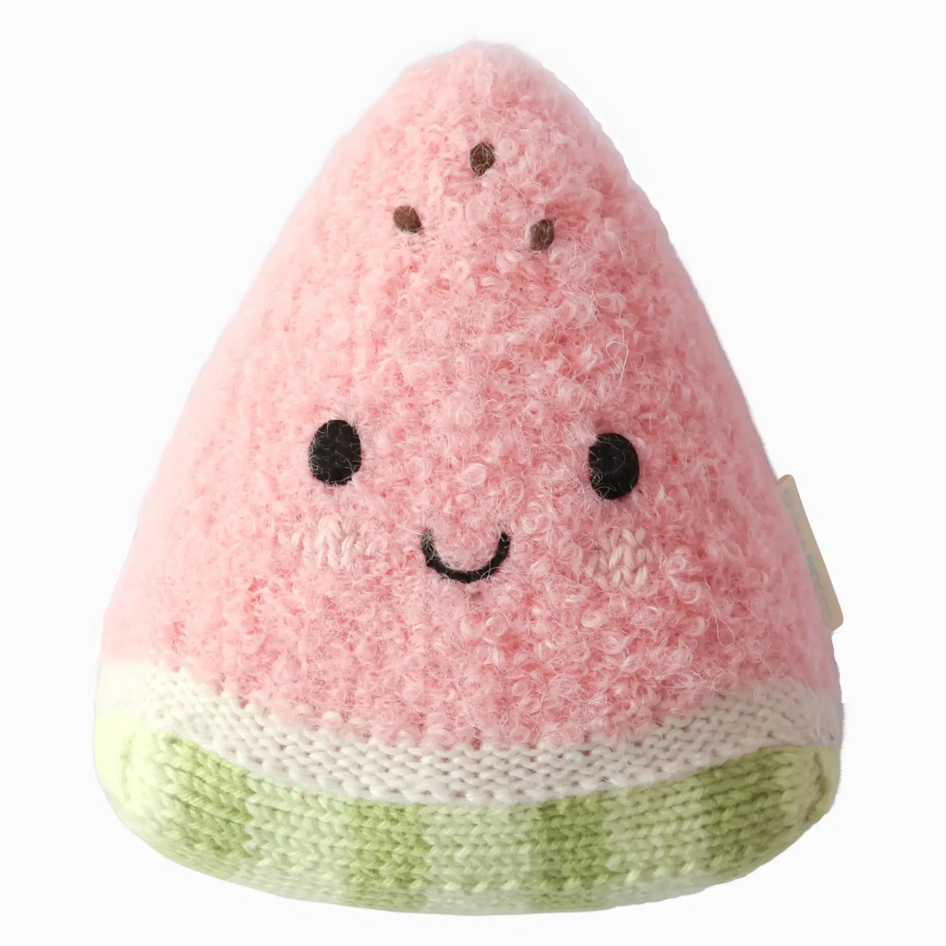 The Cuddle + Kind Baby Watermelon is a handcrafted cotton plush toy shaped like a smiling pink watermelon slice, complete with black eyes and brown seed details on a white background—a soft and delightful companion for little ones.