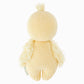 The Baby Duckling by Cuddle + Kind is a knitted yellow plush toy resembling a chick, shown from the back, featuring textured wings and a small tuft on its head. Lovingly handcrafted from soft Peruvian cotton yarn, this charming piece is one of our artisanal cotton toys.
