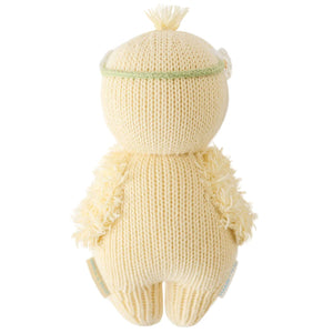 The Cuddle + Kind Baby Duckling Ivory Floral is an heirloom-quality, hand-knit plush toy with a round head, small ears, a green headband, and shown from the back.