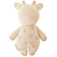 The Baby Giraffe by Cuddle + Kind is a hand-knit plush toy, shown from the back, made with heirloom-quality Peruvian cotton yarn in light beige and finished with embroidered spots.