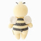 The Cuddle + Kind Bee - Baby 7" is an heirloom-quality, hand-knit plush bee doll, pictured from the back with yellow and black stripes, small wings, and two antennae—a charming addition to any collection of hand-knit baby animals.