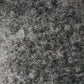 Close-up of a textured gray wool fabric with tight curls and loops, showing detailed fibers and a soft, fuzzy appearance—just like the gentle finish found on the Baby Bat - Charcoal by Cuddle + Kind.