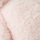 Close-up view of the soft, light pink, curly texture of the Cuddle + Kind Baby Boucle Bear - Strawberry.