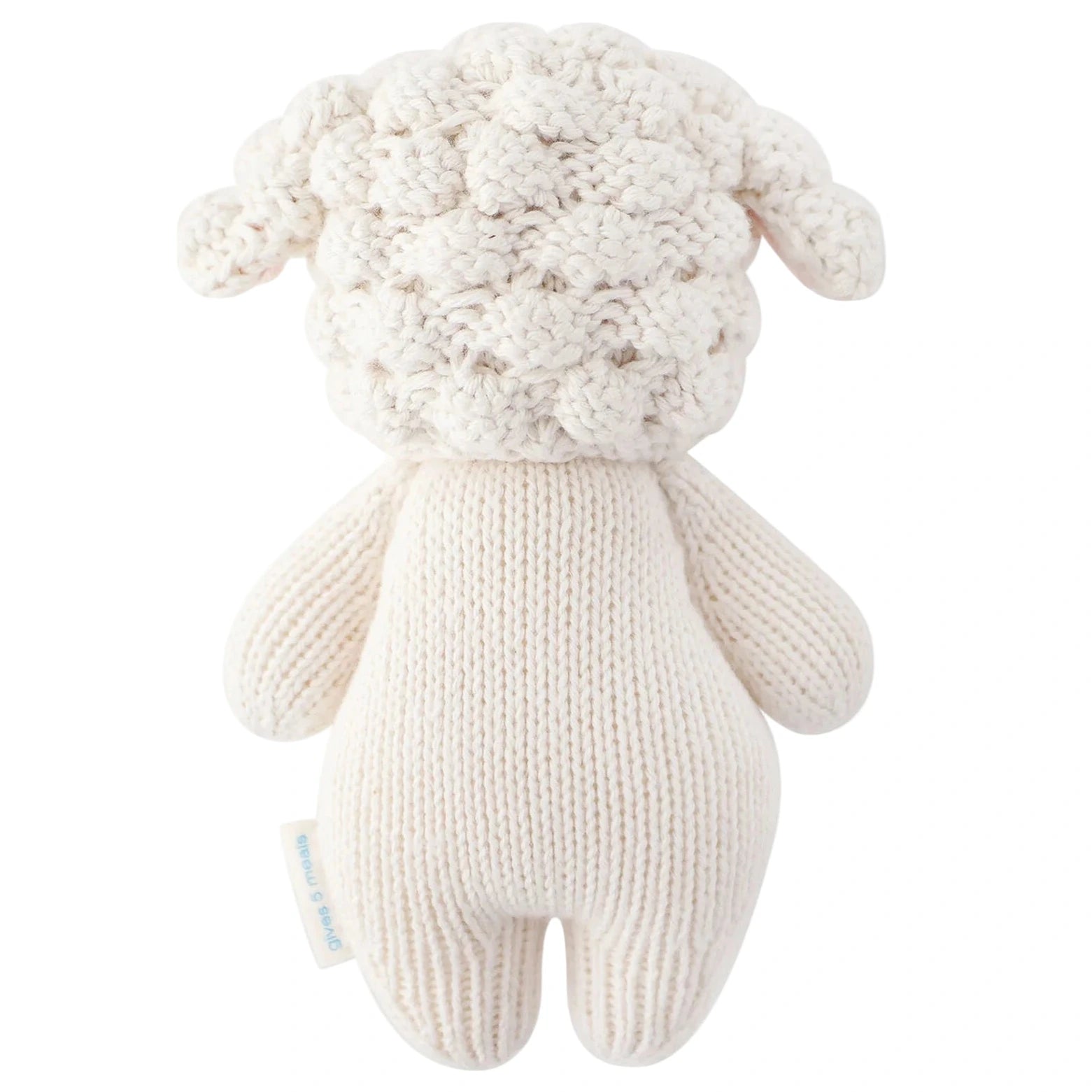 The Baby Lamb by Cuddle + Kind is a handcrafted stuffed animal made with cotton yarn, featuring a textured head and plain off-white body, resembling a sheep shown from the back.