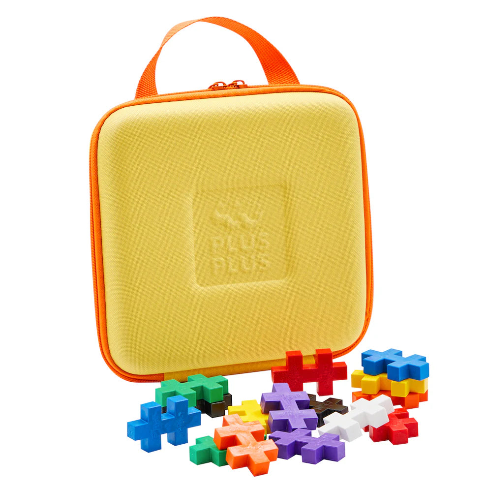 The Plus Plus BIG Travel Case by Plus Plus, featuring a yellow case with an orange handle and colorful puzzle pieces, is the perfect STEM toy for fun and learning on the go.