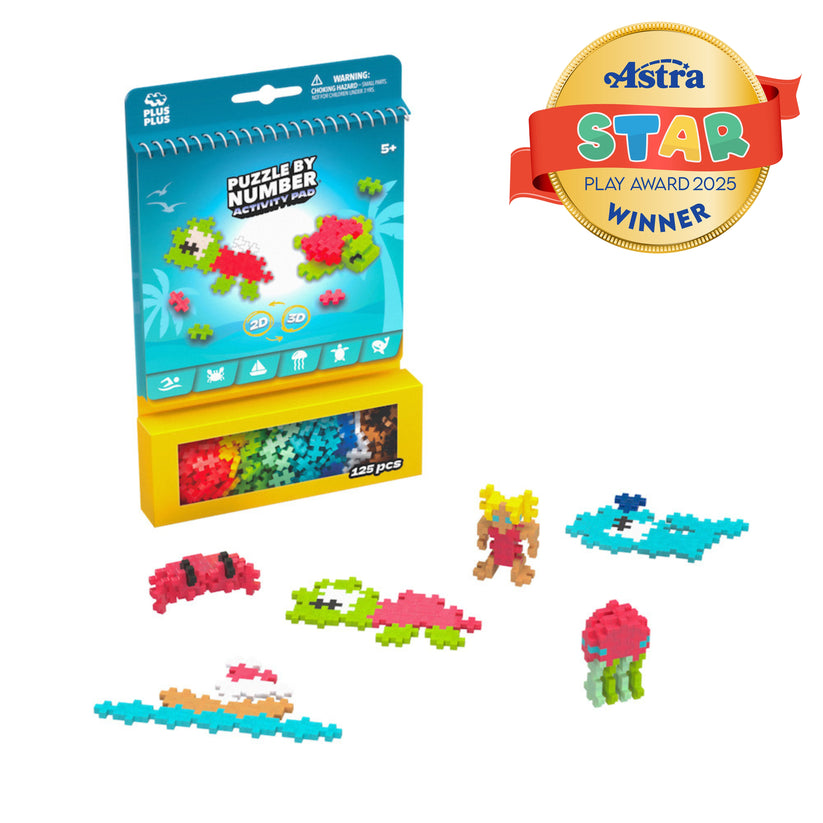 A box of Plus Plus Puzzle By Number® Activity Pad with sea creature builds beside it highlights the endless creativity this set inspires; an “Astra Star Play Award 2025 Winner” badge is in the top right corner, emphasizing its support for fine motor skill development.