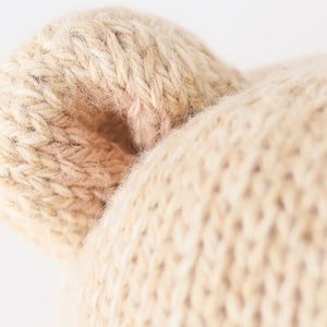 Close-up of Baby Honey Bear’s beige ear and head by Cuddle + Kind, hand-knit from soft Peruvian cotton yarn with detailed, heirloom-quality texture.
