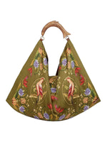 Farm Rio’s Satin Scarf Medium Bag features olive green fabric with floral and bird print, plus a sculpted fish-shaped wooden handle—a standout accessory for bold style and tropical flair lovers.