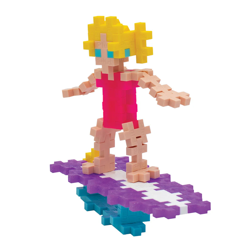 The Plus Plus Tube - Surfer Girl lets kids build a yellow-haired figure in a pink outfit on a purple and white surfboard over blue water, inspiring creative play and aiding fine motor skill development.