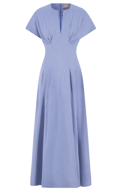 The Smocked Back Dress by Lela Rose features light blue cotton poplin, a pleat-tailored bodice, fitted waist, small V-shaped neckline, and short sleeves.