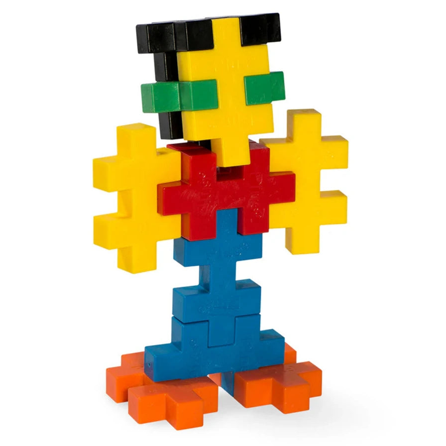 A colorful figure, built from 15 Plus Plus BIG Basic interlocking blocks in yellow, red, blue, green, orange, and black by Plus Plus, stands upright—a perfect STEM toy for creative play and fine motor skill development.