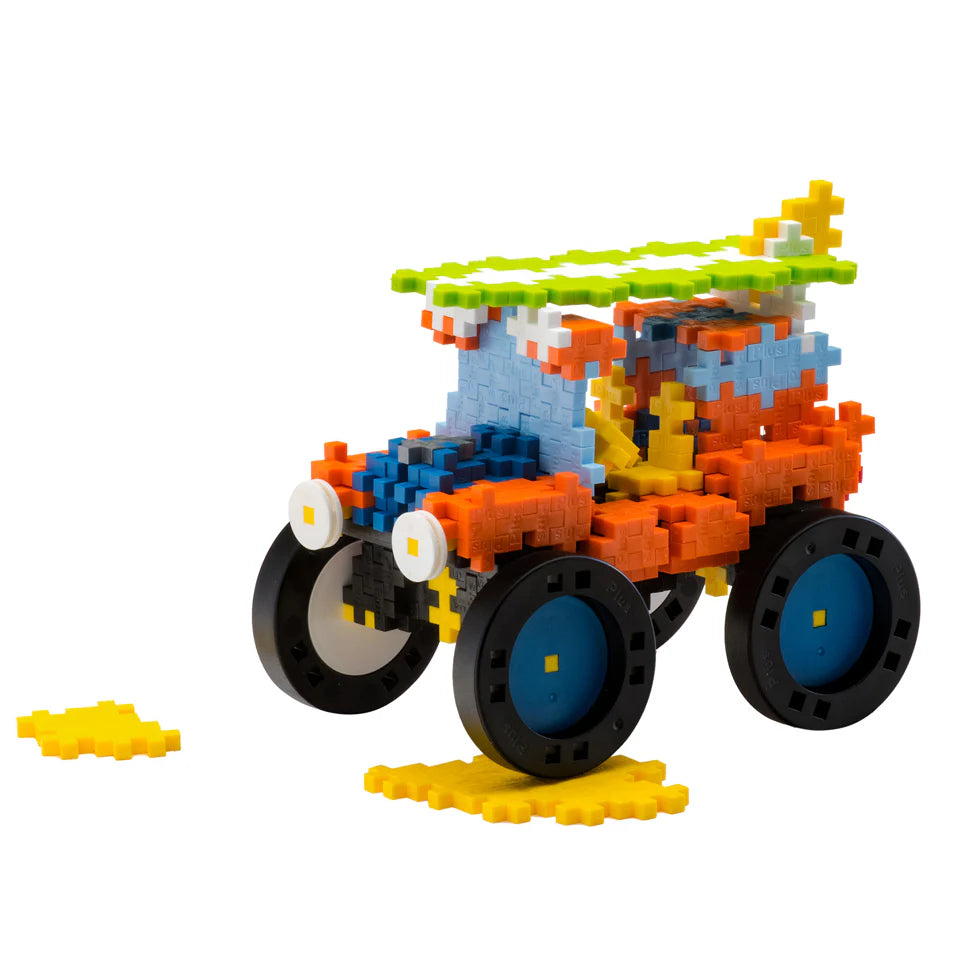 The Plus Plus GO! Learn To Build Vehicles - Super Set is a STEM toy car kit with colorful interlocking blocks, large black wheels, and extra yellow pieces—perfect for creative play and building fine motor skills.