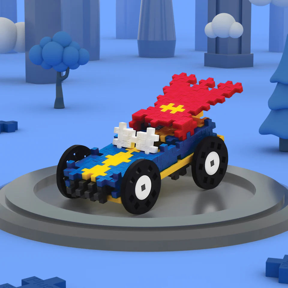 The Plus Plus Tube - Color Cars - Hero is a STEM toy car built from interlocking blocks, featuring large black wheels, a red rear spoiler, and a yellow and blue body—ideal for creative play in any blue-themed setting.
