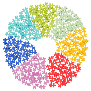 The Plus Plus Tube - 240 Piece Tropical Mix features colorful interlocking pieces arranged in a circle around a white center, creating a vibrant STEM toy that inspires creativity and builds fine motor skills.