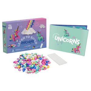 The Plus Plus Learn To Build - Unicorns kit includes a box, instruction booklet, white base plate, and colorful pieces—perfect for creative play and developing fine motor skills as a fun STEM toy.