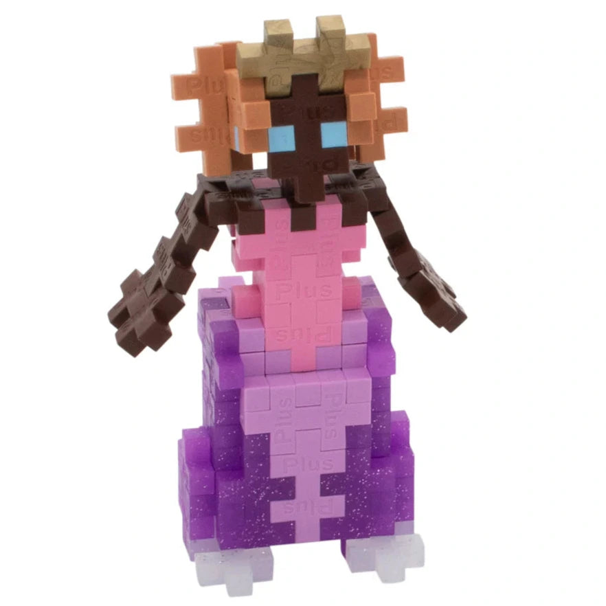 The Plus Plus Tube - Princess is a figure built from interlocking plastic blocks for creative play and fine motor skills, featuring brown and tan hair, blue eyes, a pink top, and purple skirt, standing upright.