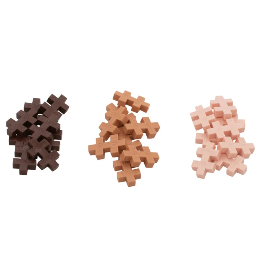 Three piles of interlocking Plus Plus pieces from the Tube - Princess set by Plus Plus in dark brown, medium brown, and light pink are arranged in a row on a white background—ideal for creative play and building fine motor skills.