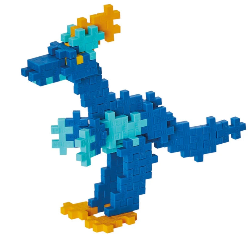 The Plus Plus Learn To Build - Dinosaurs set lets you create a blue dinosaur with yellow feet and spikes, and light blue accents. Includes interlocking plastic blocks and an illustrated guidebook to help you build different dinosaurs.