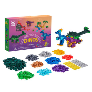 The Plus Plus Learn To Build - Dinosaurs kit includes a box, colorful plastic building pieces, two base plates, an illustrated guidebook, and a completed dinosaur model.