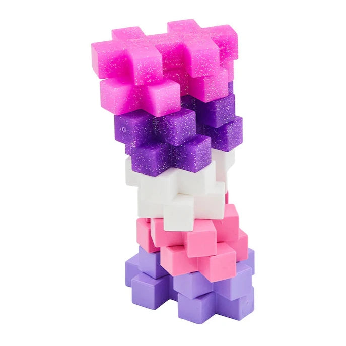 A vertical stack of Plus-Plus BIG 15 Piece Tube - Glitter by Plus Plus, featuring sparkling pink, purple, and white pieces for endless 3-D building fun against a white background.