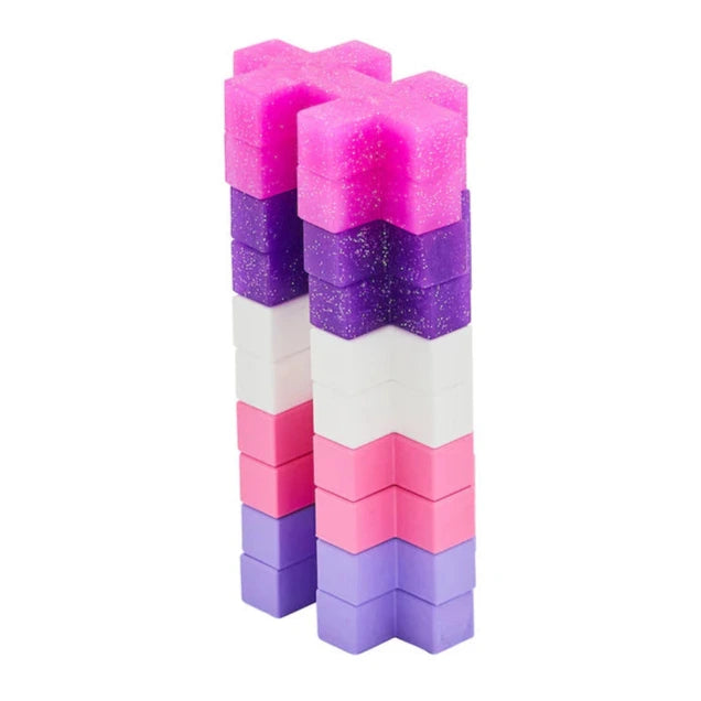 Two vertical stacks of Plus Plus BIG 15 Piece Tube - Glitter blocks in pink, purple, and white create an eye-catching toy by Plus Plus, perfect for creative 3-D building fun.