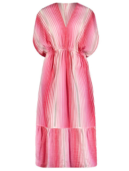 The lemlem Leila Plunge Dress by Lemlem is a versatile long dress with pink and white vertical stripes, featuring a gathered waist and a flowing, layered hem, hand-woven in Ethiopia.