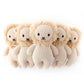 Five identical Cuddle + Kind Baby Lion plush toys with beige bodies and fluffy manes are arranged in a row on a white background—perfect hand-knit collectibles for any nursery.
