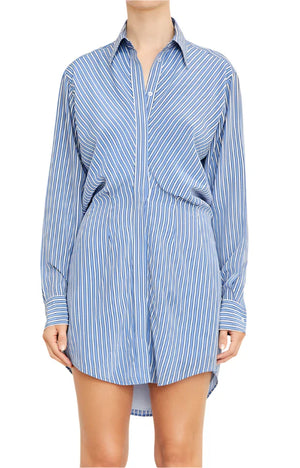 A person wearing the Vera Shirtdress by Brandon Maxwell, a blue and white striped shirtdress elegantly tailored from premium silk.