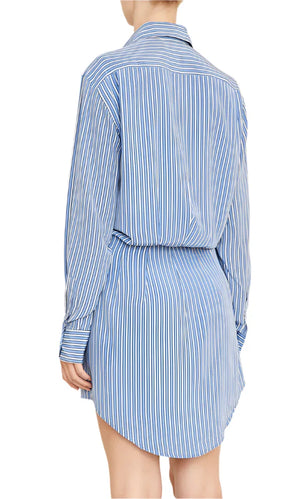 A person is seen gracefully from the back wearing the expertly tailored Vera Shirtdress by Brandon Maxwell, featuring premium blue and white stripes.