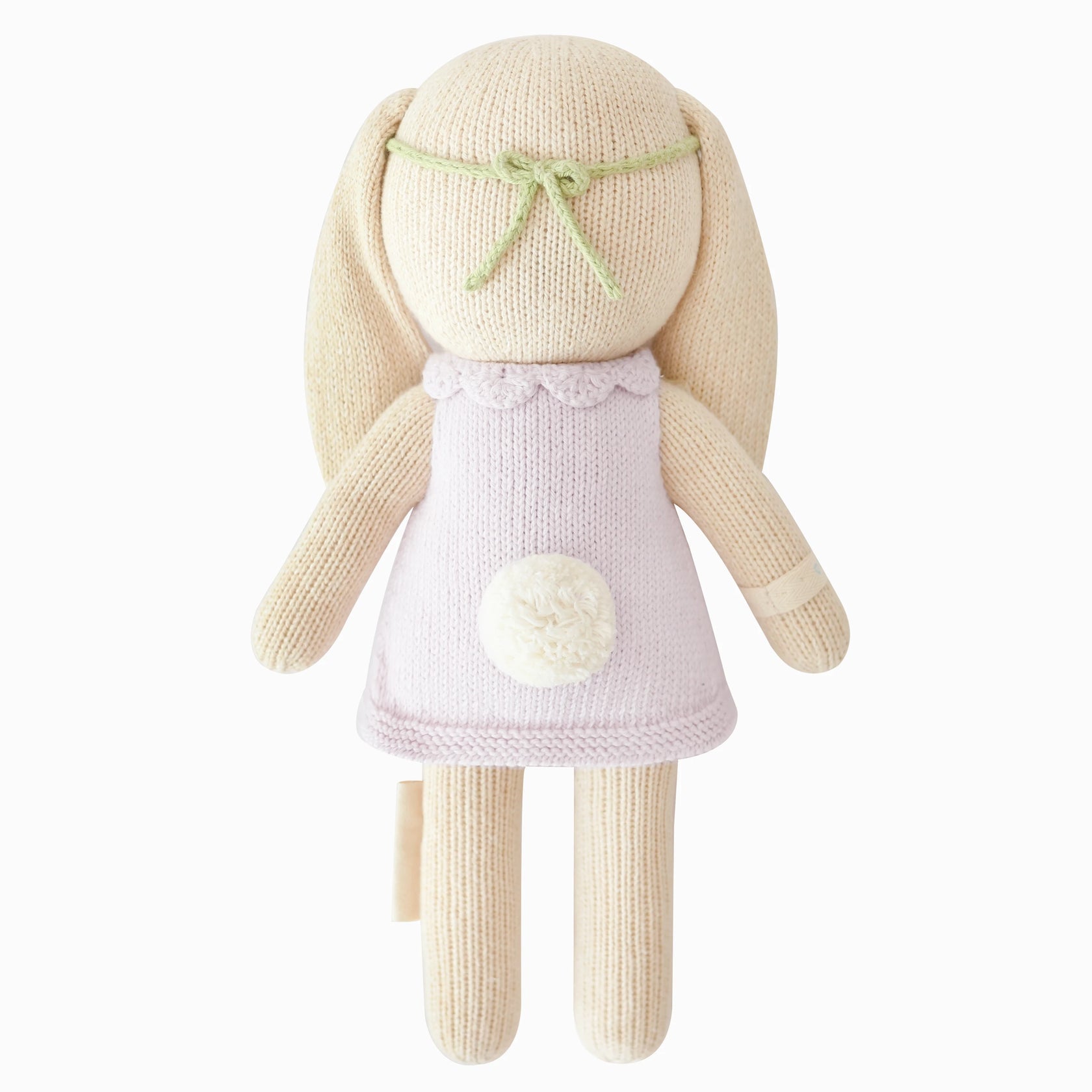 Hannah the Bunny Violet - Little 13" by Cuddle + Kind is a delightful knit bunny doll with long ears, dressed in a light purple dress and green headband, and finished with a white pompom tail. Set against a white background, this charming plush toy makes an ideal inspirational gift or birthday present for all ages.
