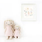 Two Cuddle + Kind Hannah the Bunny plushies in blush dresses and flower crowns sit side by side with a floral print behind them—a sweet 20" gift for any occasion.