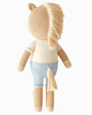 Liam the Pony - Regular 20" by Cuddle + Kind is a charming stuffed plush toy, viewed from the back, featuring a beige body, blue pants, tan yarn mane and tail, and light brown arms and legs—a delightful friendship plush that's perfect as a birthday gift for someone special.