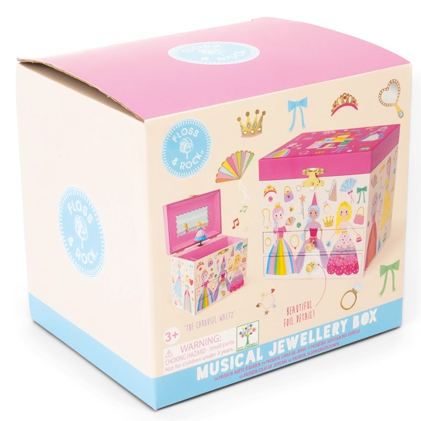 A cardboard box showcases a vibrant illustration of the Floss and Rock Musical Jewelry Box – Princess, decorated with crowns, wands, and delightful princess motifs. The packaging features prominent product branding, highlights the enchanting carousel waltz melody played by the jewelry box, and clearly indicates it is suitable for ages 3 and up.