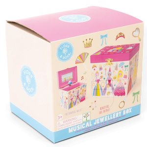 A cardboard box showcases a vibrant illustration of the Floss and Rock Musical Jewelry Box – Princess, decorated with crowns, wands, and delightful princess motifs. The packaging features prominent product branding, highlights the enchanting carousel waltz melody played by the jewelry box, and clearly indicates it is suitable for ages 3 and up.