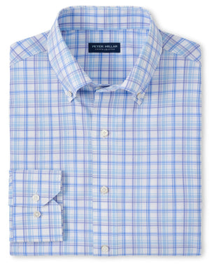 The Peter Millar Mullen Performance Poplin Sport Shirt is a folded blue and white plaid dress shirt featuring a button-down collar, crafted from performance fabric with moisture-wicking properties and an interior brand label.