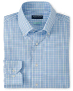 The Peter Millar Seawell Cotton Sport Shirt, a men's tailored-fit light blue button-up with a subtle plaid pattern, features a button-down collar and an unfolded left cuff for a sleek look.