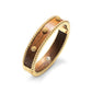 The Berry Small Hinged Bangle by Juliska Capucine De Wulf features beaded edging and raised gold accents, shown on a white background—ideal for stacking in your golden jewelry collection.