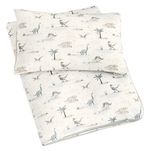 The Gooselings Dino Dreams Toddler Duvet with Insert features a charming dinosaur print with various dinosaurs and palm trees on a light background, ideal for transitioning from toddler to big-kid bed.
