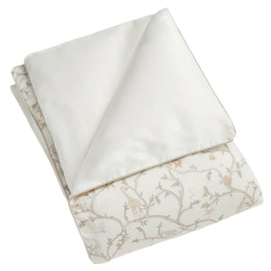 The Animal Parade Ivory Toddler Duvet with Insert by Gooselings is perfect for big-kid beds, featuring a reversible side with trees and animals like giraffes and elephants, making it a cozy layer that nurtures dreams and creates an inviting space for your child's adventures.