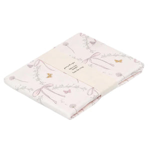 The Bows & Butterfly Kisses Swaddle by Gooselings is expertly crafted from 100% cotton, featuring pastel floral and bow designs with delicate butterflies—ideal for a nursery.