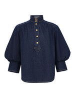 Zimmermann Denim Billow shirt in Harbour Blue with a high collar, gold-tone front buttons, and voluminous sleeves with wide cuffs.
