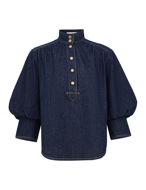 Zimmermann Denim Billow shirt in Harbour Blue with a high collar, gold-tone front buttons, and voluminous sleeves with wide cuffs.