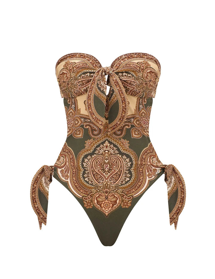 Zimmermann Mahon Scarf Tie One Piece features a strapless olive paisley print, front keyhole cutout, and side tie details, shown on a plain white background.