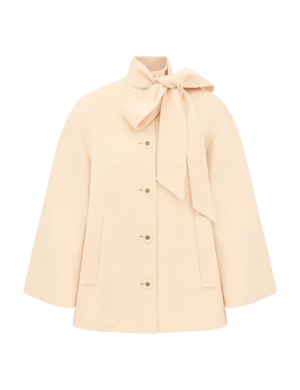 The Zimmermann Valiant Pussybow Coat features beige long sleeves, front buttons, two pockets, and a large neck bow—ideal for your Fall 2026 wardrobe.