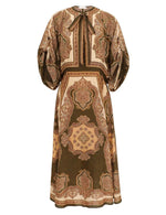 The Mahon Tunic Midi Dress by Zimmermann features brown and beige paisley silk, voluminous sleeves, and a tied neckline—perfect for summer 2026.