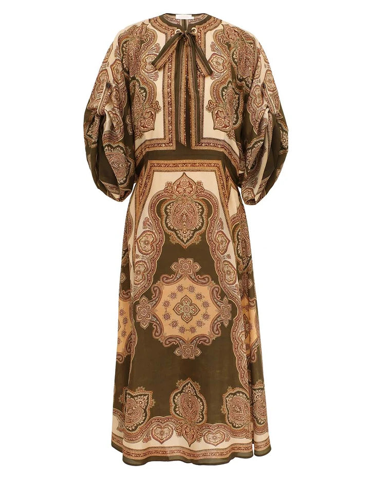 The Mahon Tunic Midi Dress by Zimmermann features brown and beige paisley silk, voluminous sleeves, and a tied neckline—perfect for summer 2026.