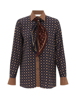 Zimmermann Relaxed Multi Geo Print Shirt: long sleeves, navy & tan geo print, tan polka-dot cuffs/collar, brown patterned neck scarf. Fall 2026 Collection.