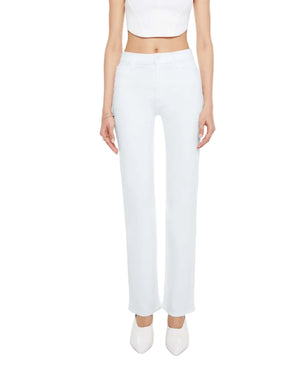 A person is wearing the Mother Kick It high-rise straight-leg jeans in a light blue wash, styled with a white crop top and white pointed shoes, standing facing forward against a plain background.